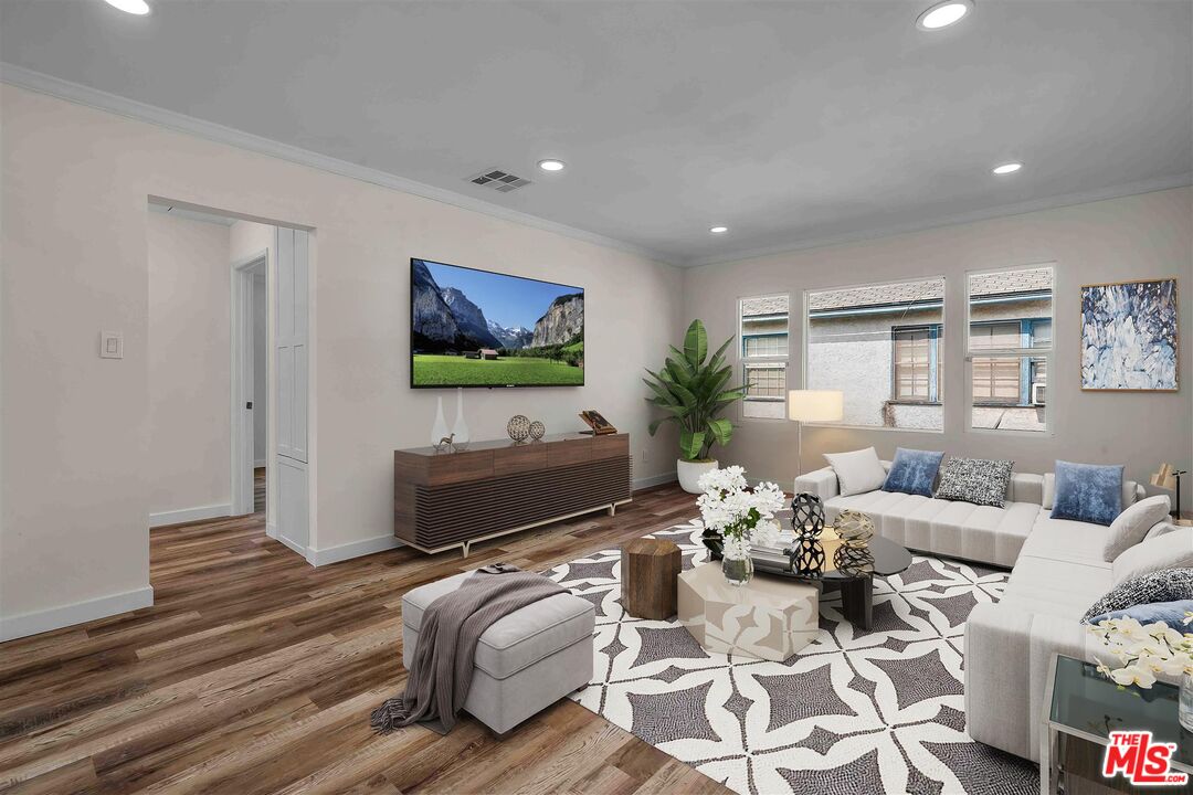11575 Riverside Drive Valley Village, CA 91602 - Photo 2 of 16 a living room with furniture a flat screen tv and a dining table