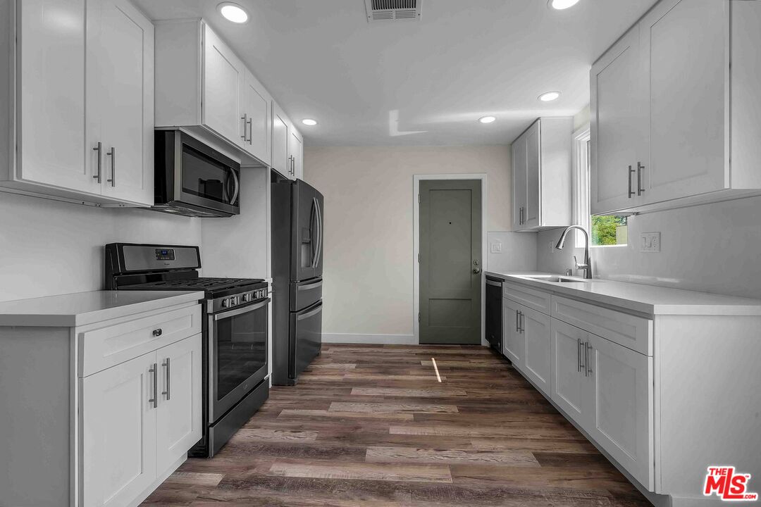 11575 Riverside Drive Valley Village, CA 91602 - Photo 4 of 16 a kitchen with stainless steel appliances granite countertop a refrigerator sink and stove
