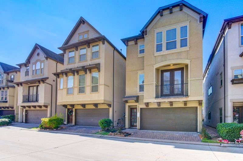 10014 Spring Shadows Park Circle Houston, TX 77080 - Photo 2 of 39 a view of a white building among the street and palm trees