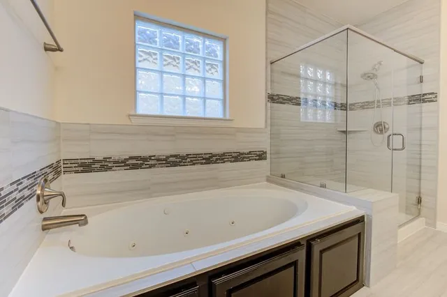 a bathroom with a granite countertop sink a toilet and shower