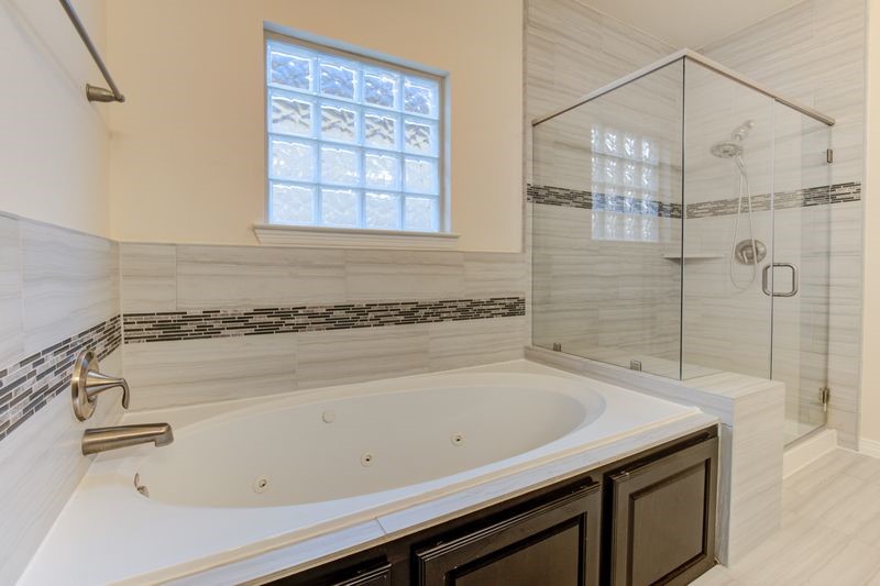 10014 Spring Shadows Park Circle Houston, TX 77080 - Photo 23 of 39 a bathroom with a granite countertop sink a toilet and shower