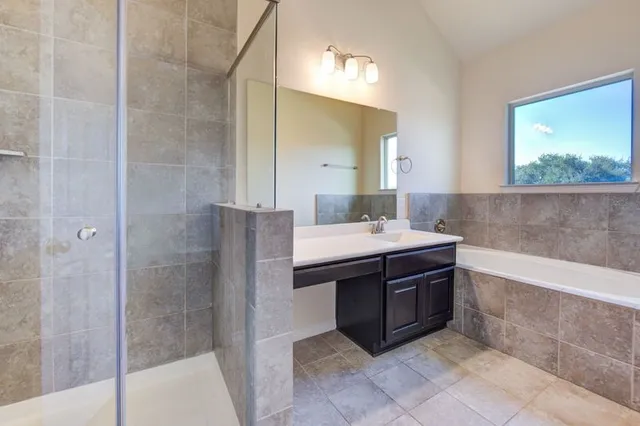 a bathroom with a bathtub and a sink