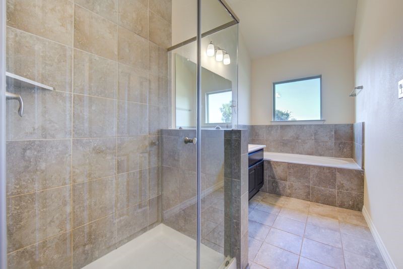 10014 Spring Shadows Park Circle Houston, TX 77080 - Photo 29 of 39 a bathroom with a bathtub and shower