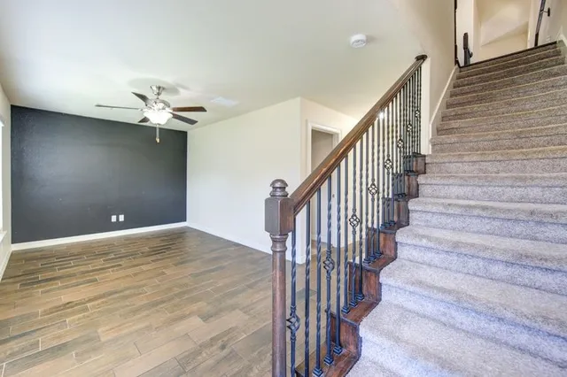 a view of entryway and hall with wooden floor