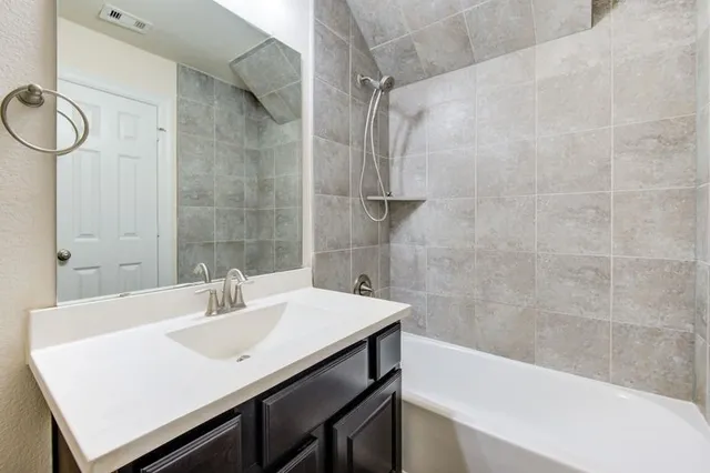 a bathroom with a sink a bathtub and a shower