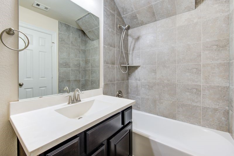 10014 Spring Shadows Park Circle Houston, TX 77080 - Photo 36 of 39 a bathroom with a sink a bathtub and a shower