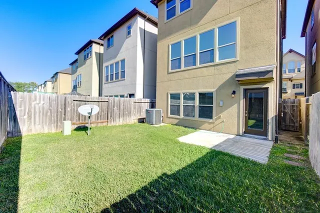 a white house with a small yard and big yard