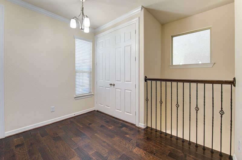 10014 Spring Shadows Park Circle Houston, TX 77080 - Photo 9 of 39 an empty room that has a window and wooden floor