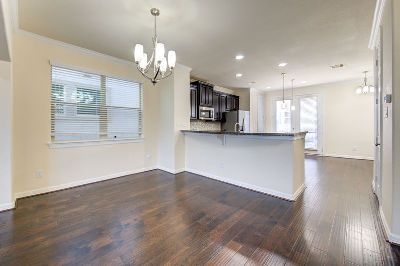 10014 Spring Shadows Park Circle Houston, TX 77080 - Photo 10 of 39 a view of a kitchen with a dishwasher cabinets and wooden floor