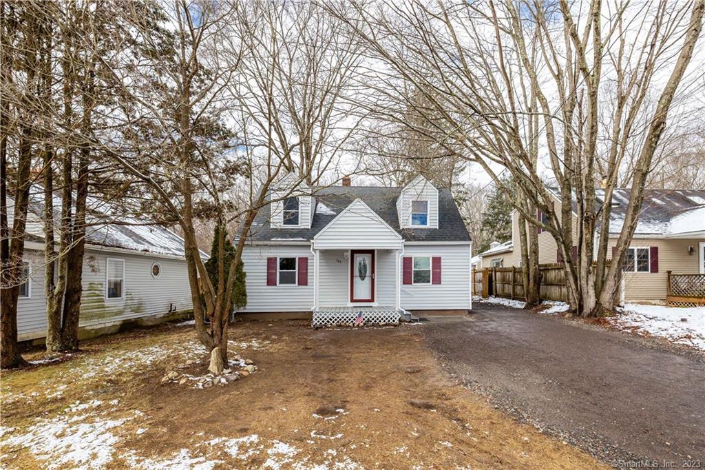 a front view of a house with a yard covered in snow