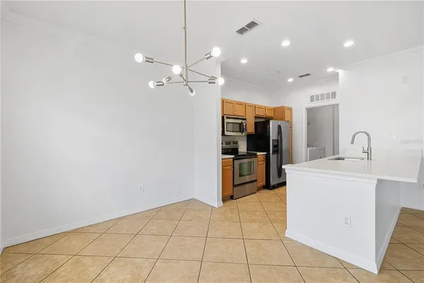 a kitchen with stainless steel appliances a stove a sink and a microwave