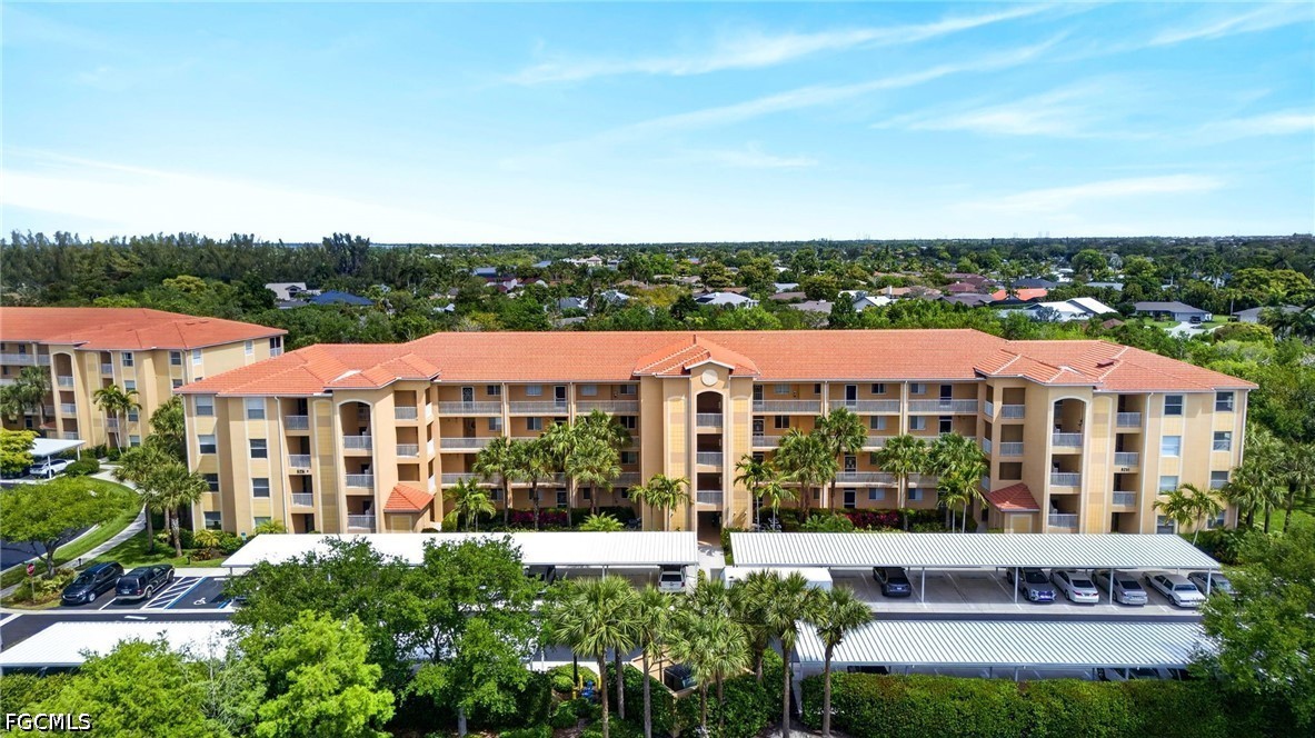 8251 Pathfinder Loop, Unit 621 Fort Myers, FL 33919 - Photo 28 of 30 a view of a building with a garden