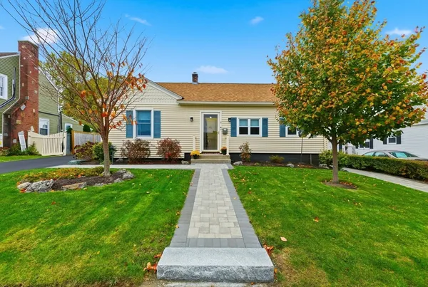 a front view of house with yard and green space
