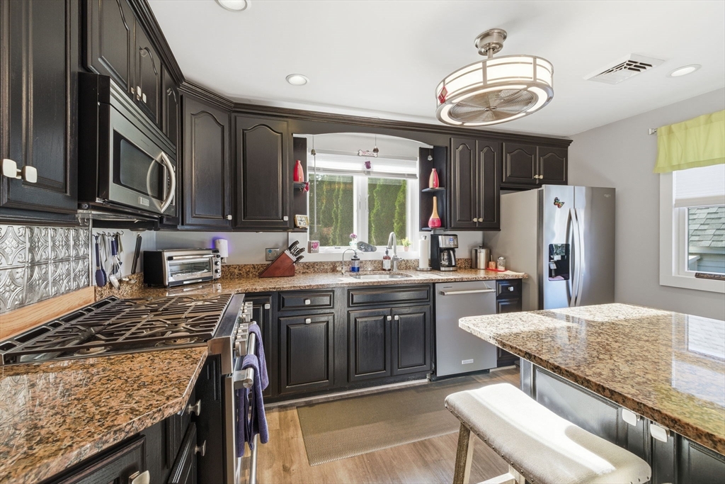 5 West Kenneth Street Lawrence, MA 01843 - Photo 14 of 41 a kitchen with stainless steel appliances granite countertop a sink stove and refrigerator