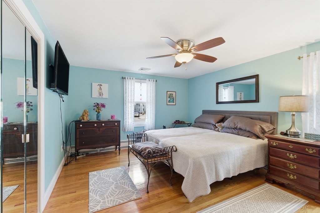 5 West Kenneth Street Lawrence, MA 01843 - Photo 17 of 41 a bedroom with a bed and a chandelier