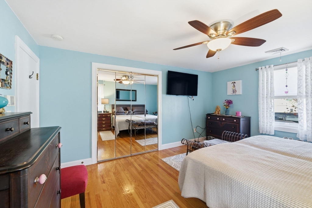 5 West Kenneth Street Lawrence, MA 01843 - Photo 19 of 41 a bedroom with a bed and a chandelier