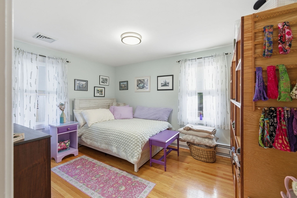 5 West Kenneth Street Lawrence, MA 01843 - Photo 22 of 41 a bedroom with a bed and a painting on the wall