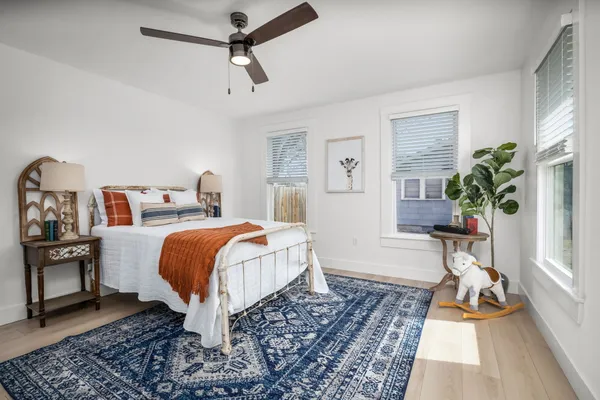 a bedroom with a bed and a potted plant