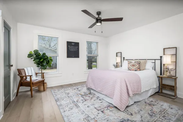 a bedroom with a large bed and a window
