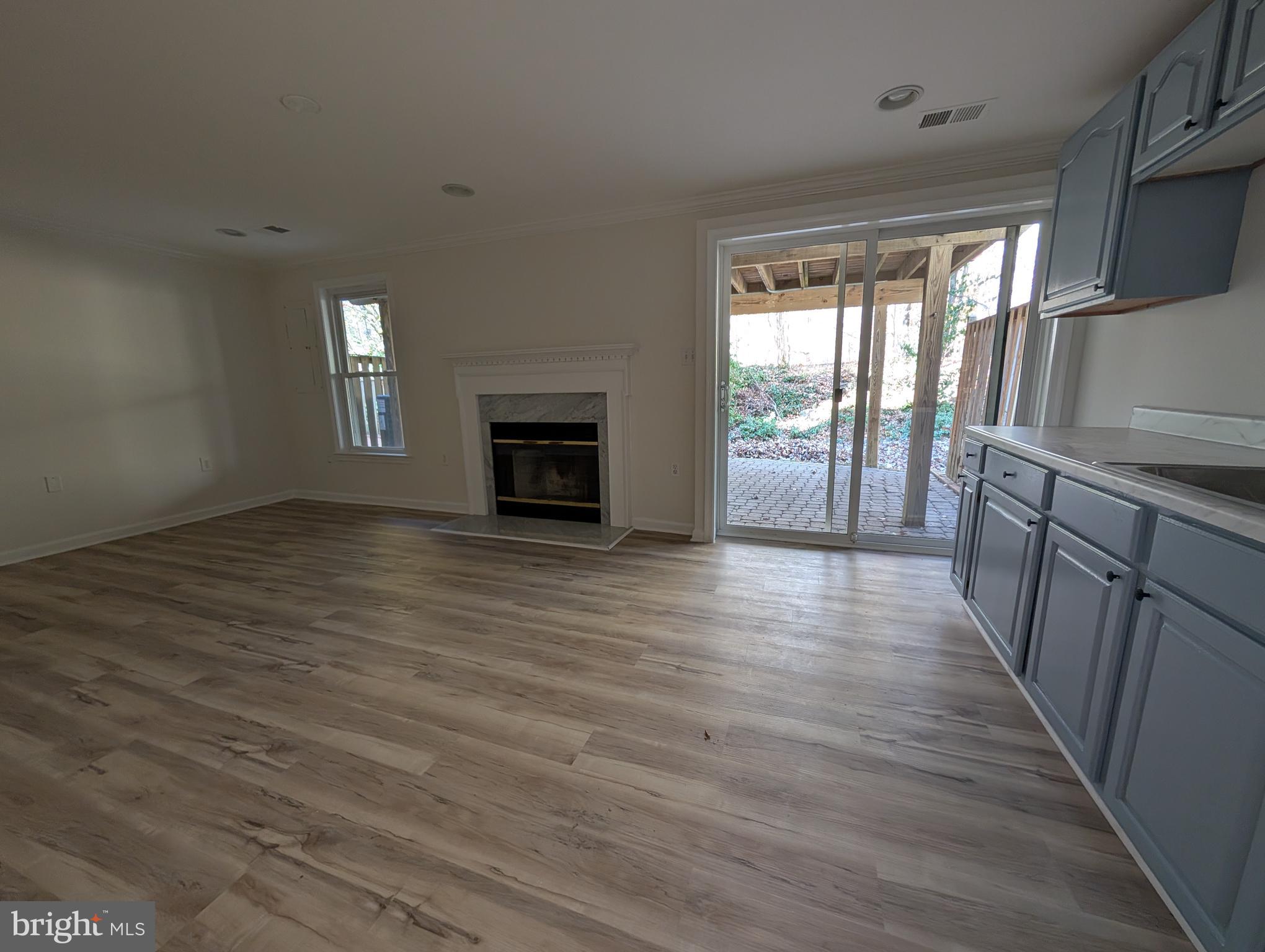 8108 Squirrel Run Road Springfield, VA 22152 - Photo 14 of 16 a view of empty room with wooden floor and fireplace