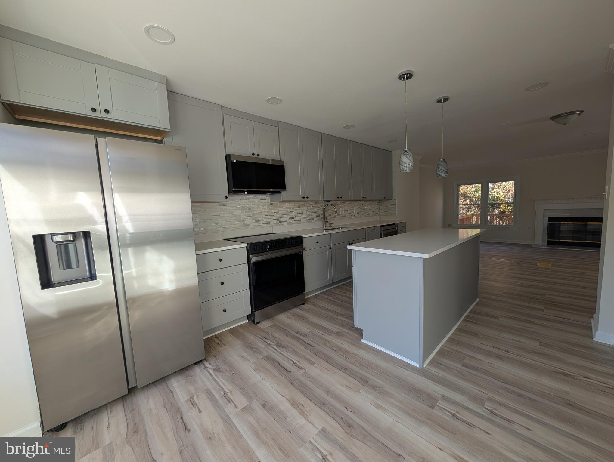 8108 Squirrel Run Road Springfield, VA 22152 - Photo 2 of 16 a kitchen with stainless steel appliances granite countertop a refrigerator a sink a stove and oven
