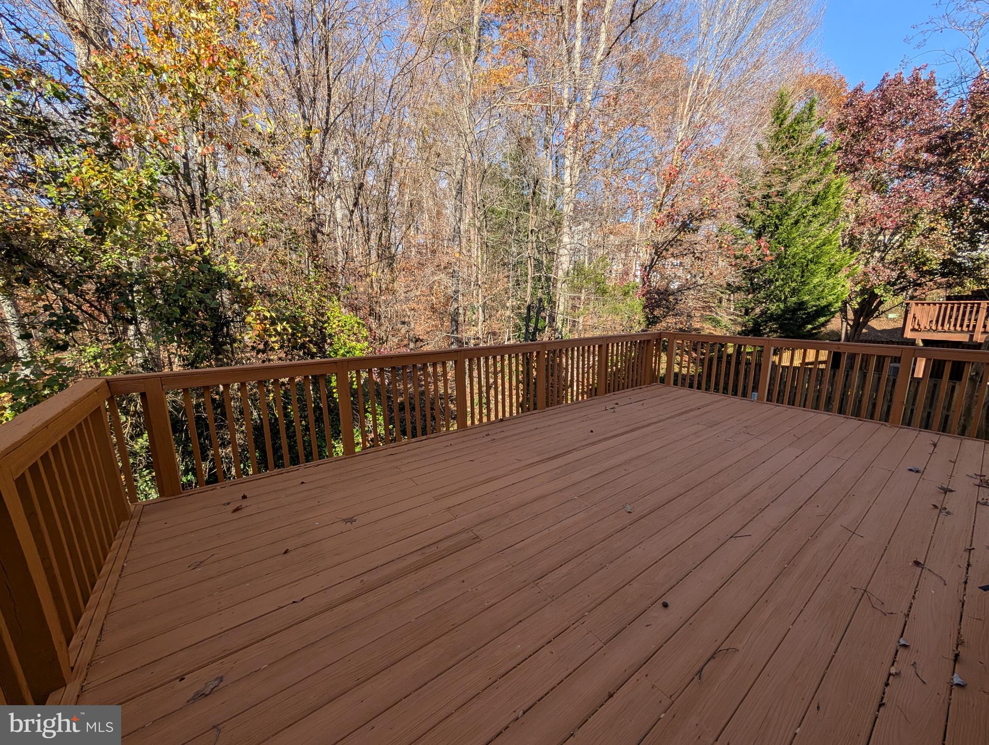 8108 Squirrel Run Road Springfield, VA 22152 - Photo 6 of 16 a view of deck with wooden floor and fence with a bench