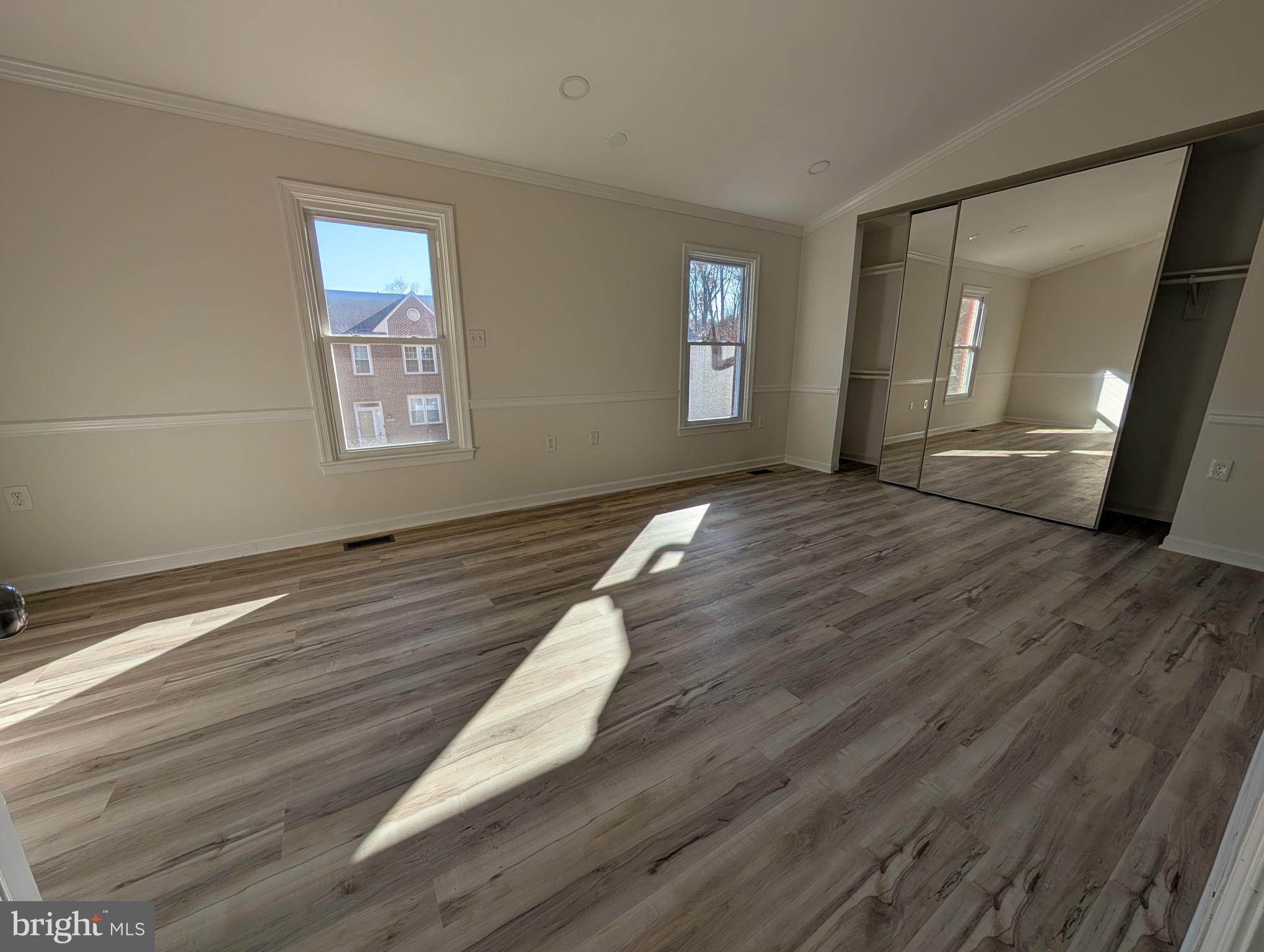 8108 Squirrel Run Road Springfield, VA 22152 - Photo 10 of 16 a view of an empty room with wooden floor and a window