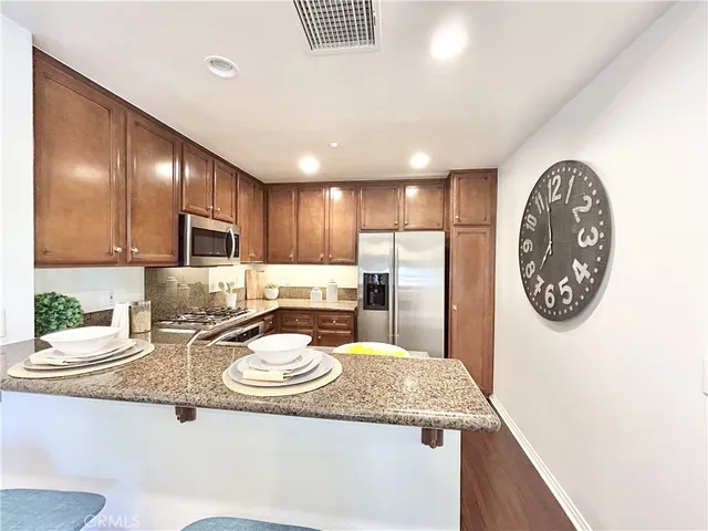 a kitchen with a sink a stove and chairs