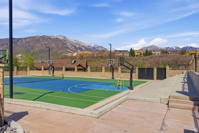 2007 Fielding Hill Lane Draper, UT 84020 - Photo 74 of 83 Multi-sport court featuring a vibrant blue and green surface with basketball hoops and a tennis net