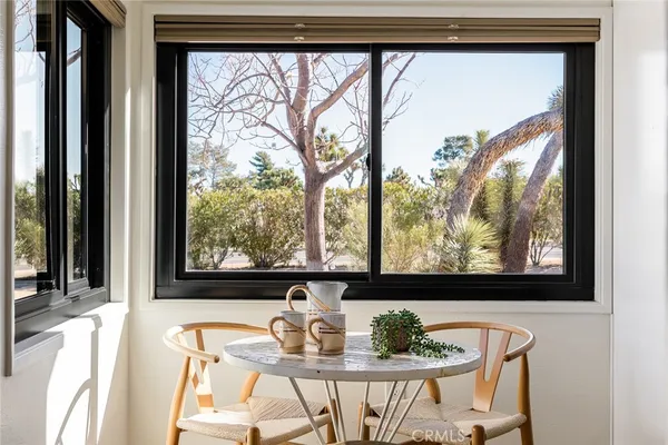 a view of a from a dining room with furniture window and outside view