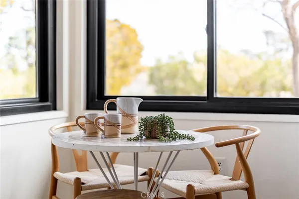 a dining room with furniture and window