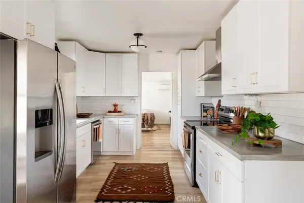 a kitchen with a sink stainless steel appliances and cabinets