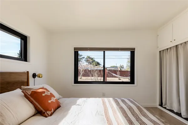 a bedroom with a bed and window
