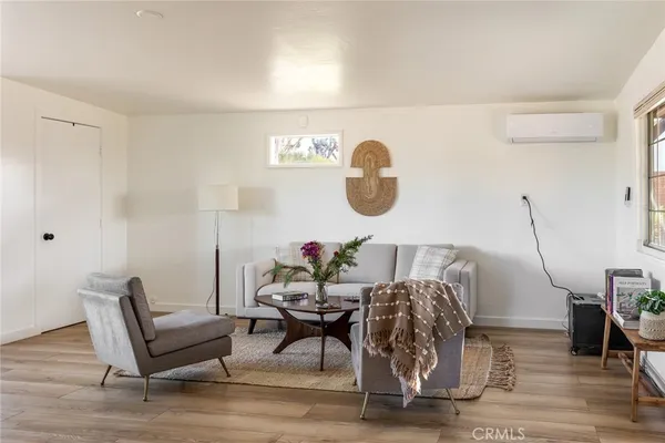 a living room with furniture and a chair