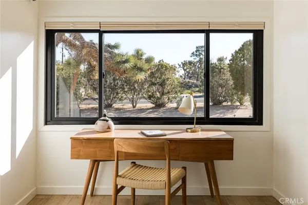 a dining room with furniture and window