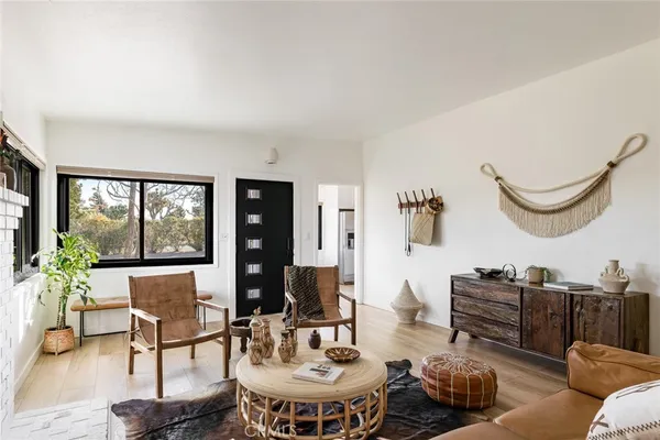 a living room with furniture a rug and a large window