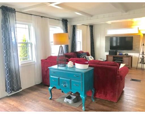 87 Parkwood Drive Wareham, MA 02571 - Photo 4 of 22 a living room with furniture a flat screen tv and a window