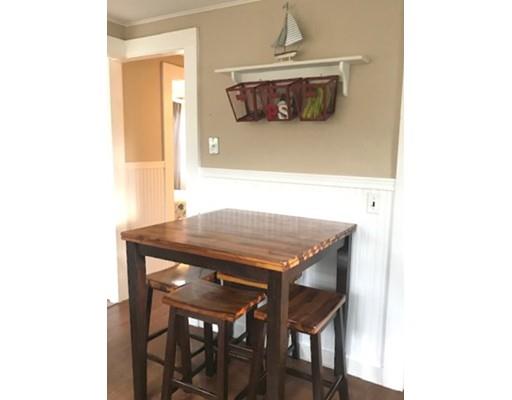 87 Parkwood Drive Wareham, MA 02571 - Photo 6 of 22 a table and chairs in a kitchen