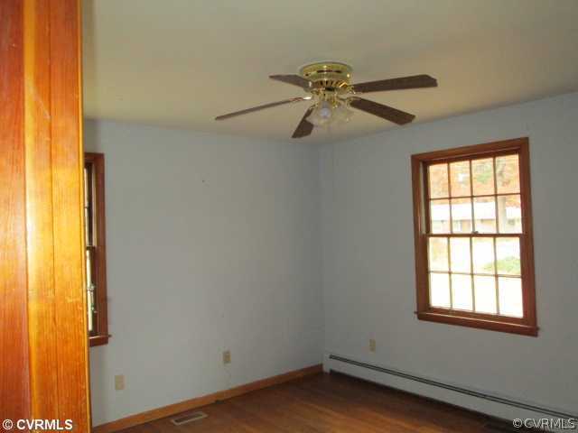 3940 Tanbark Road Richmond, VA 23235 - Photo 7 of 10 an empty room with windows and fan