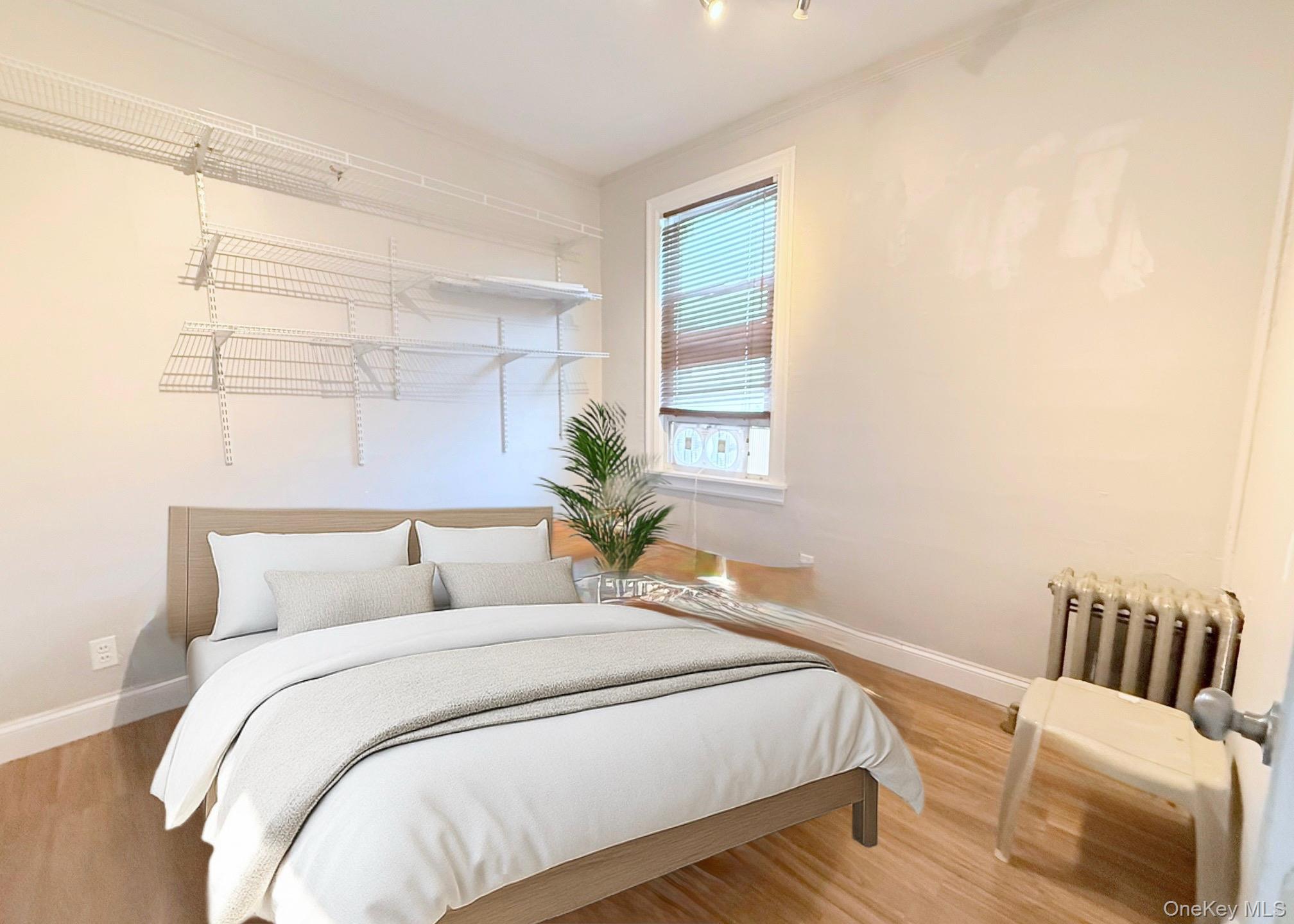 35 7th Street New Rochelle, NY 10801 - Photo 14 of 18 a bedroom with a bed and a window