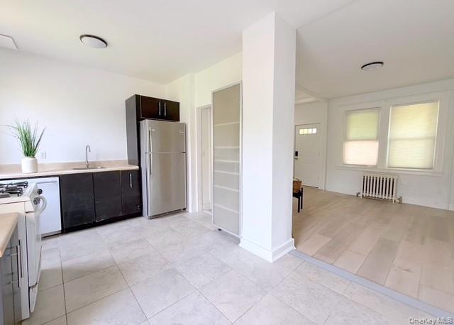 35 7th Street New Rochelle, NY 10801 - Photo 8 of 18 a view of a kitchen with refrigerator and windows