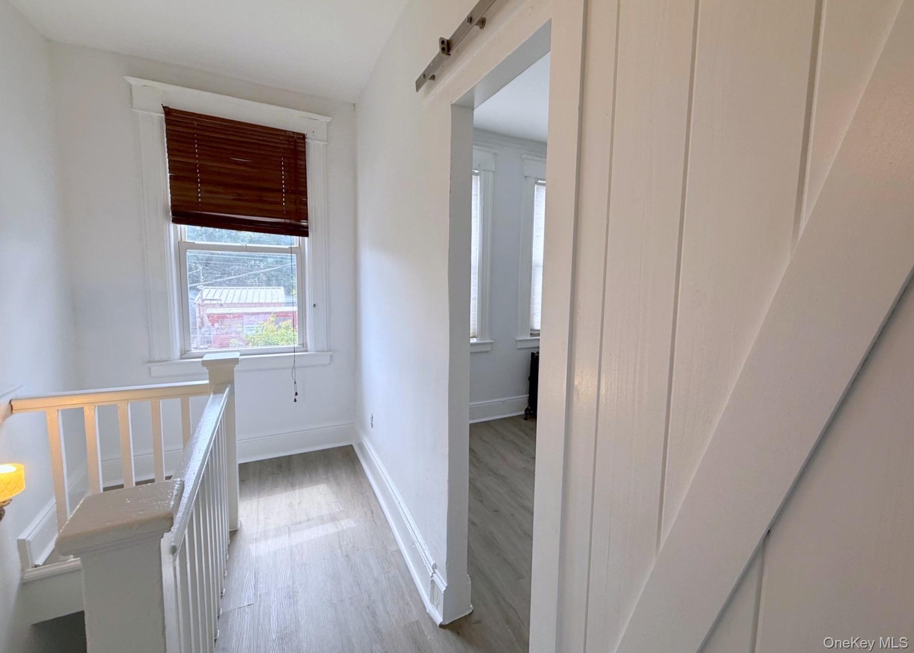 35 7th Street New Rochelle, NY 10801 - Photo 10 of 18 a view of hallway with wooden floor and stairs