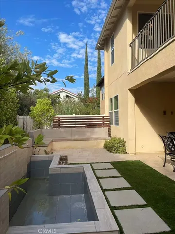 a view of a backyard with sitting area