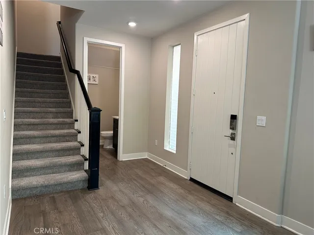a view of an entryway with wooden floor