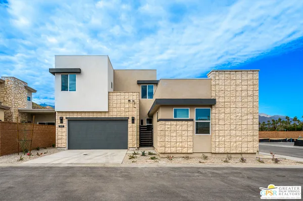 a front view of a house with a road