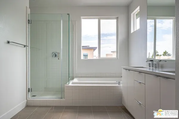 a bathroom with a bathtub a shower and a sink