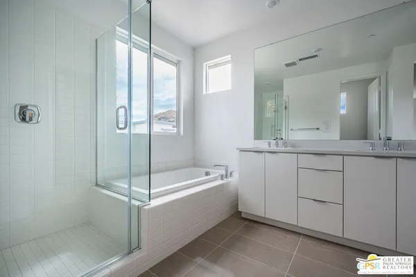 a bathroom with a double vanity sink and mirror