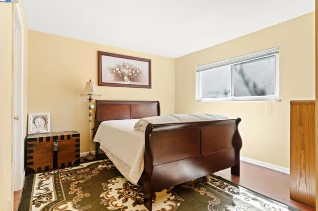 a bed sitting in a bedroom next to a window