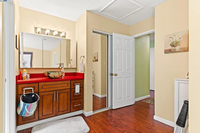 a utility room with closet and wooden floors