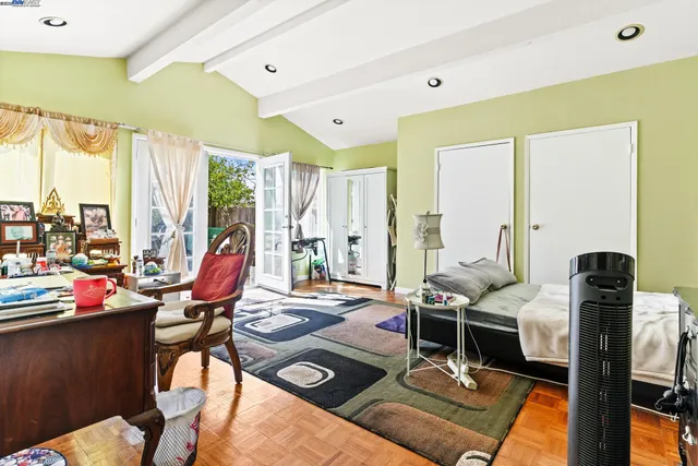 a view of a workspace with furniture and floor to ceiling window